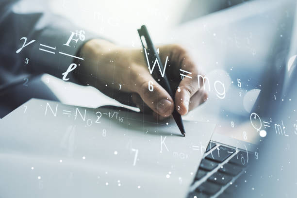 istock Creative scientific formula concept with hand writing in notebook on background with laptop. Multiexposure 1302981718