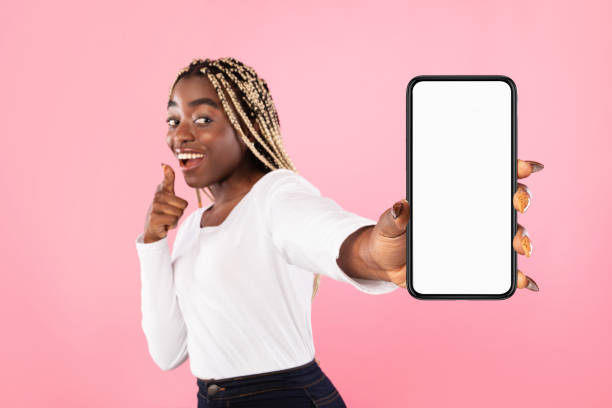 istock Black woman showing blank smartphone screen for mockup 1302982729