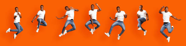 istock Collage of jumping stylish black guy on orange 1302983561