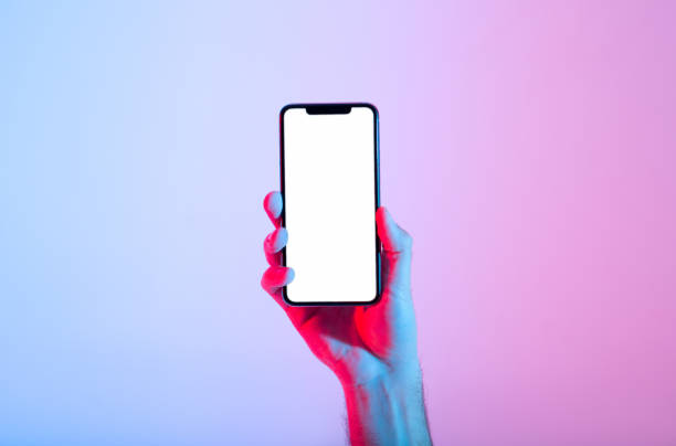 Good app, place for text, advertising, great offer in modern devices Good app, place for text, advertising, great offer in modern devices. Male millennial hand holds modern smartphone with blank luminous screen, in neon, studio shot, cut out, close up, free space fluorescent photos stock pictures, royalty-free photos & images
