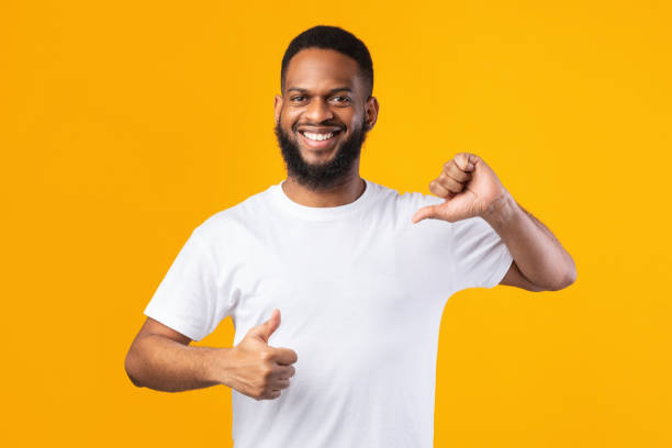 istock Cheerful Black Guy Pointing Thumbs At Himself On Yellow Background 1302985978