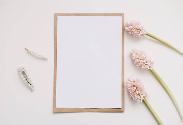 istock mockup with pink flowers and blank paper with copy space. 1302986337