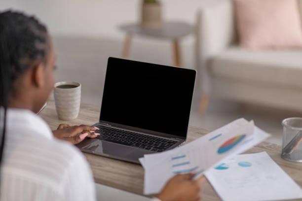 istock African lady ceo having online conference from home, using laptop 1302986722