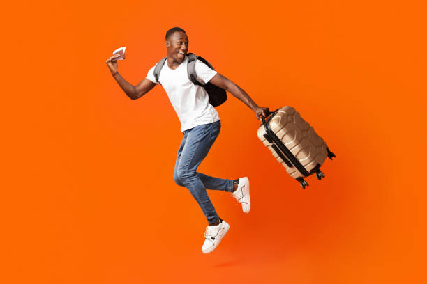 istock Happy man with passport and suitcase running and looking back 1302987220