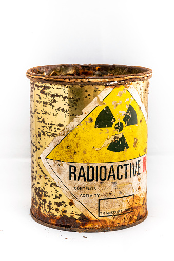 Radiation warning sign on transport index label stick on the old and rusted cylinder shape container of Radioactive material