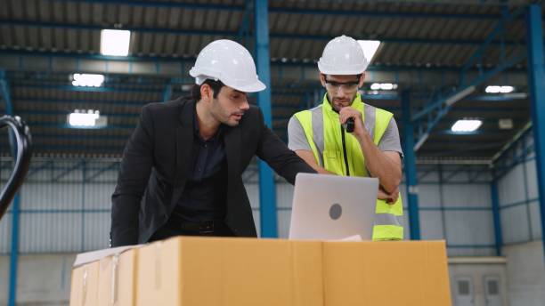 istock Two factory workers working and discussing manufacturing plan in the factory . 1302994875