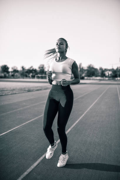 istock Female Jogging In Place Before Setting Out On Running Track 1302998063