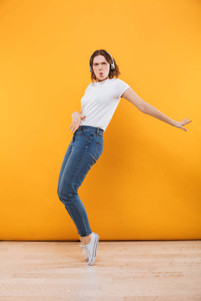 istock Emotional funny young woman dancing isolated 1302999122