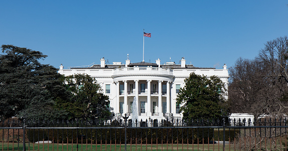 The White House lit up at night in Washington DC, USA.