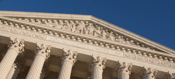 Close-up of the US Supreme Court in Washington, D.C. with a bright blue sky. Close-up of the US Supreme Court in Washington, D.C. with a bright blue sky. us supreme court stock pictures, royalty-free photos & images