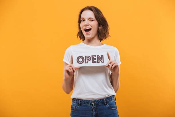 istock Cheerful young woman with open shopping blank 1303000799