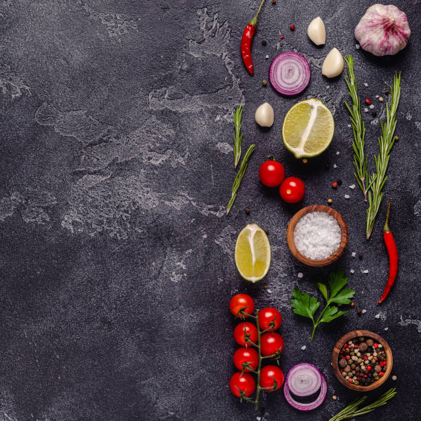 istock Herbs and condiments on black stone background 1303001452