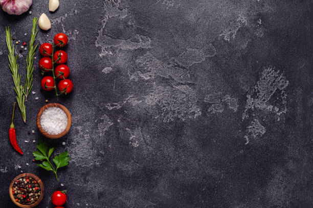 istock Herbs and condiments on black stone background 1303002025