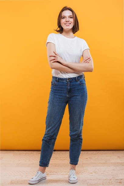 istock Happy young woman standing isolated 1303002888