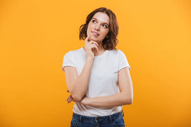 istock Thinking cute young woman standing isolated 1303002958