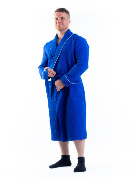 istock strong man in a Bathrobe on an isolated white background with a smile on his face. 1303003716