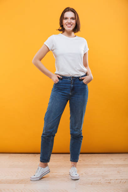 istock Happy young woman standing isolated 1303004248