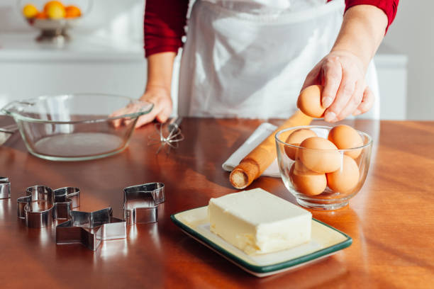 istock Close Up Of Woman Using Eggs And Butter 1303004876