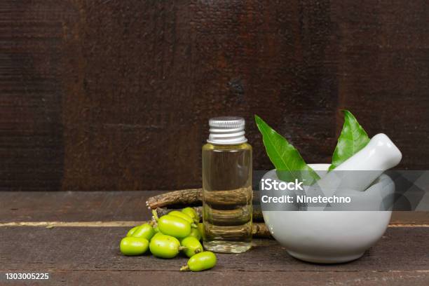 Neem Oil In Bottle And Neem Leaf In Mortar And Pestle Stock Photo - Download Image Now