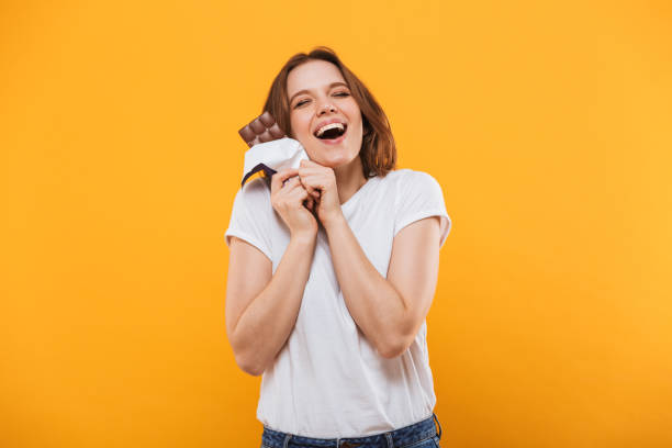 Happy cute young woman holding chocolate.