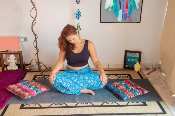 istock yoga teacher doing stretching movements 1303005334