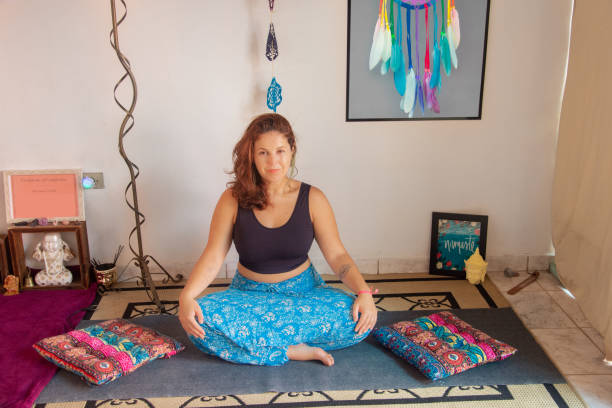 istock yoga teacher doing stretching movements 1303005357
