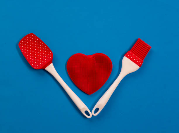 istock Silicone kitchen utensils with a red heart and a place for text. Kitchen banner for Valentine's Day. 1303005437