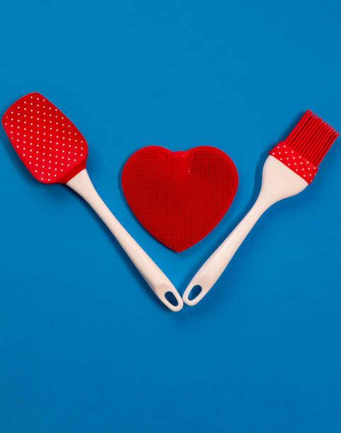 istock Silicone kitchen utensils with a red heart and a place for text. Kitchen banner for Valentine's Day. 1303005452