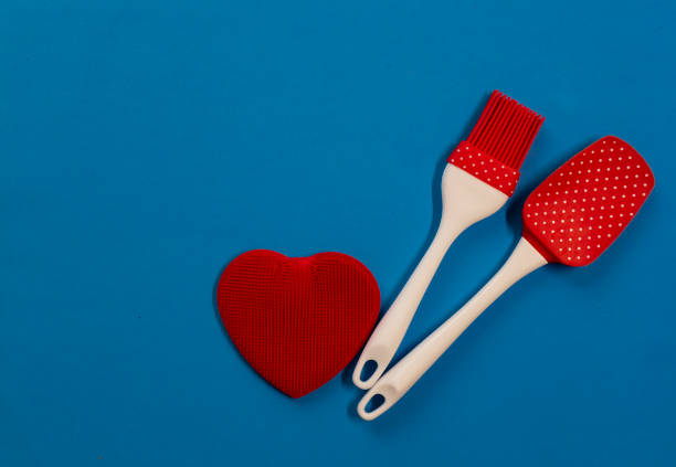 istock Silicone kitchen utensils with a red heart and a place for text. Kitchen banner for Valentine's Day. 1303005487