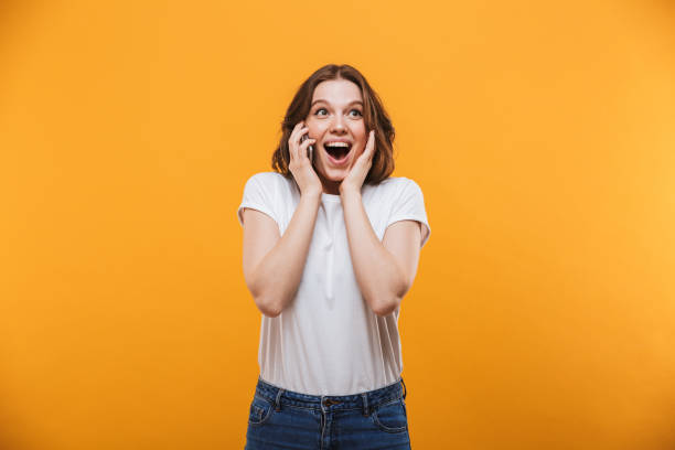 istock Surprised young woman talking by mobile phone. Looking aside 1303005569