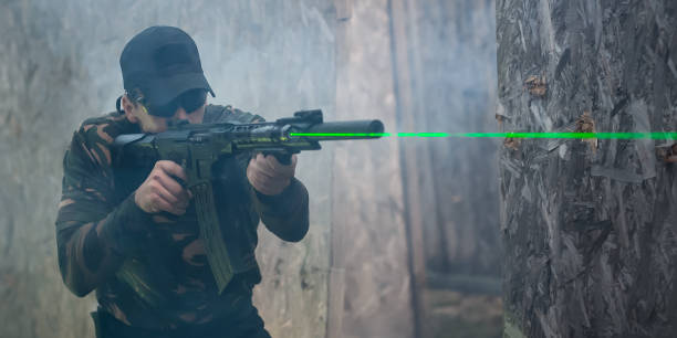 istock Army soldier in action aiming at weapon laser sight optics 1303006924
