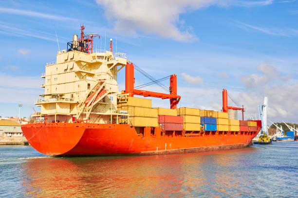 istock Tugboat pulls a large cargo ship to port. Transportation and logistics work 1303008625