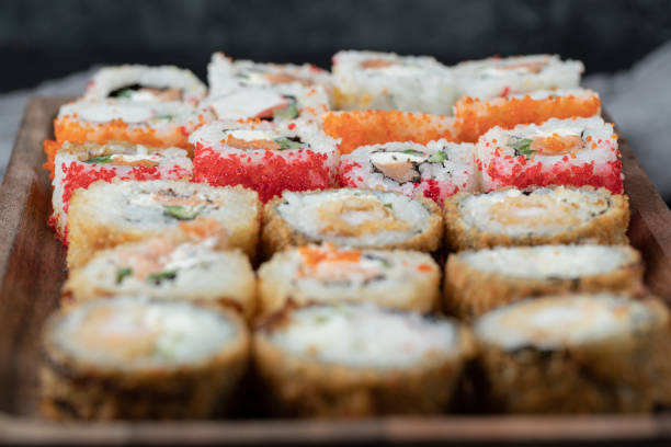 istock Sushi set on a wooden board with mixed ingredients 1303008757