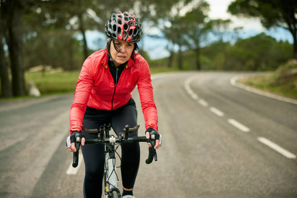 istock Early 50s Female Triathlete Training on Racing Bicycle 1303009752