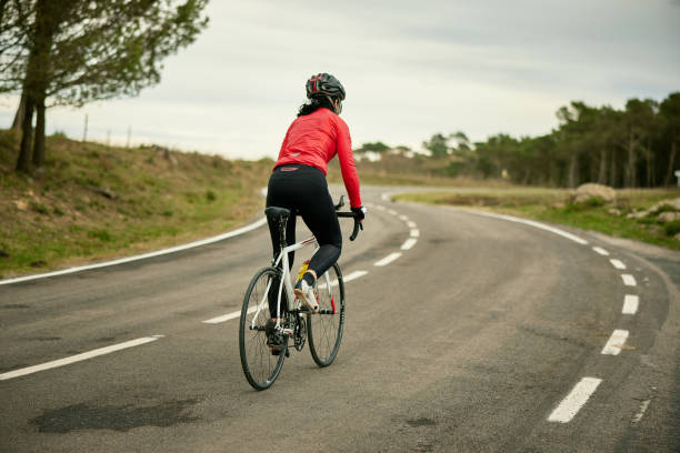istock Mature Female Triathlete Training on Racing Bicycle 1303009759
