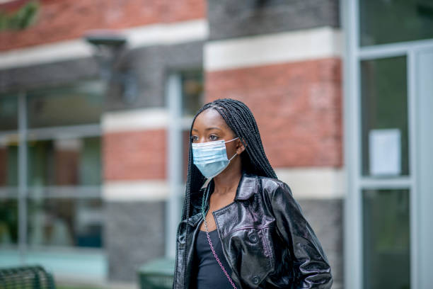 istock Young African woman wearing a face mask 1303010214