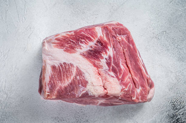 istock Raw pork neck meat for Chop steak on kichen table. White background. Top view 1303012229