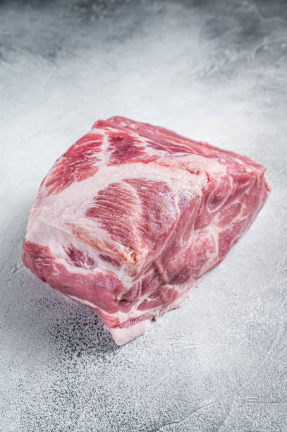 istock Raw pork neck meat for Chop steak on kichen table. White background. Top view 1303012247