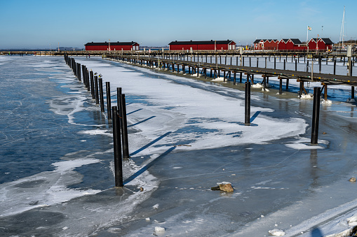 Ice covering a yacht marina. Blue sky background. Picture from Lomma, southern Sweden