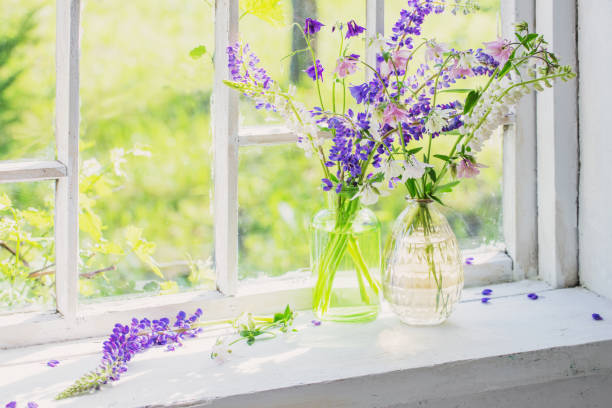 istock summer flowers in vase on windowsill in sunlight 1303019432