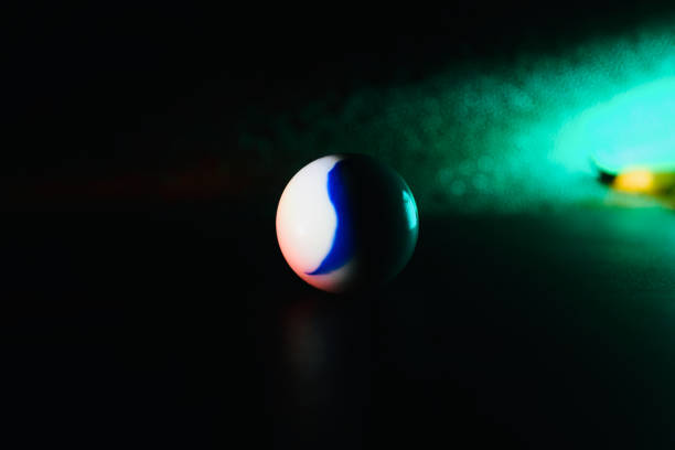 istock White marble balls with green lights background 1303019706