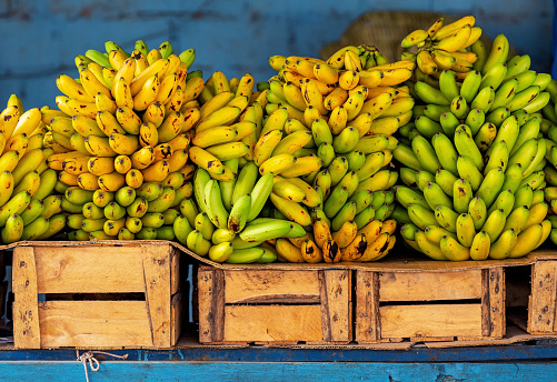 Bananas on crates for sale on local market, Guayaquil, Ecuador.