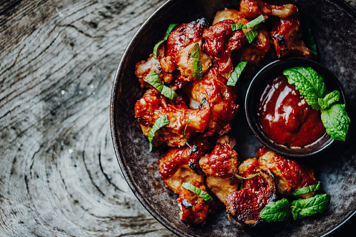 Vegan Buffalo Wings Made of Cauliflower Florets with BBQ-Sauce