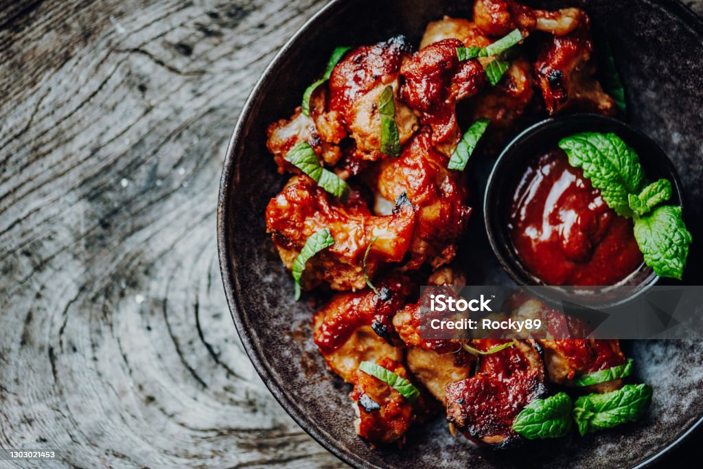 Vegan Buffalo Wings Made of Cauliflower Florets with BBQ-Sauce Chicken Wing Stock Photo