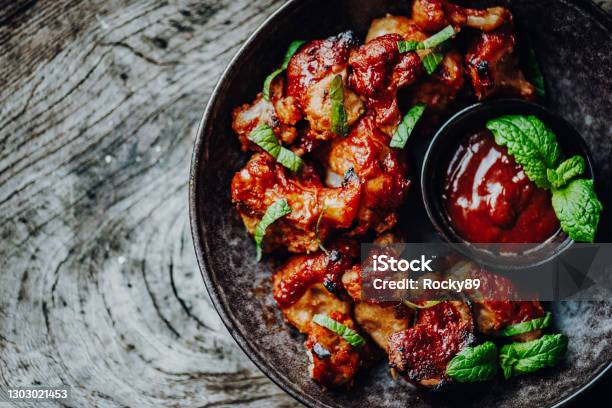 Vegan Buffalo Wings Made Of Cauliflower Florets With Bbqsauce Stock Photo - Download Image Now