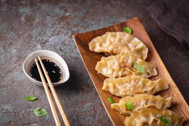 istock Asian dumplings with soy sauce 1303021564