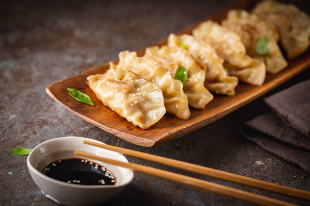 istock Asian dumplings with soy sauce 1303021568