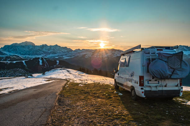 The sun is rising over the Mont Blanc, and shine on a van. The valley bellow is cover with snow but the sky is blue and clear. A wonderfull day is starting!