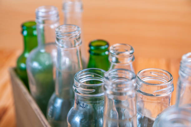istock Empty glass bottles in a case on wooden board for recycling 1303022698