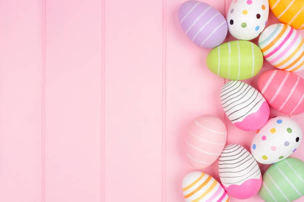 istock Colorful Easter Egg side border over a soft pink wood background 1303023773